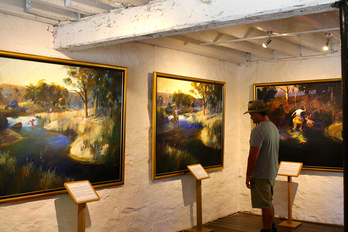 Man looking at art in a country town museum in Tamworth