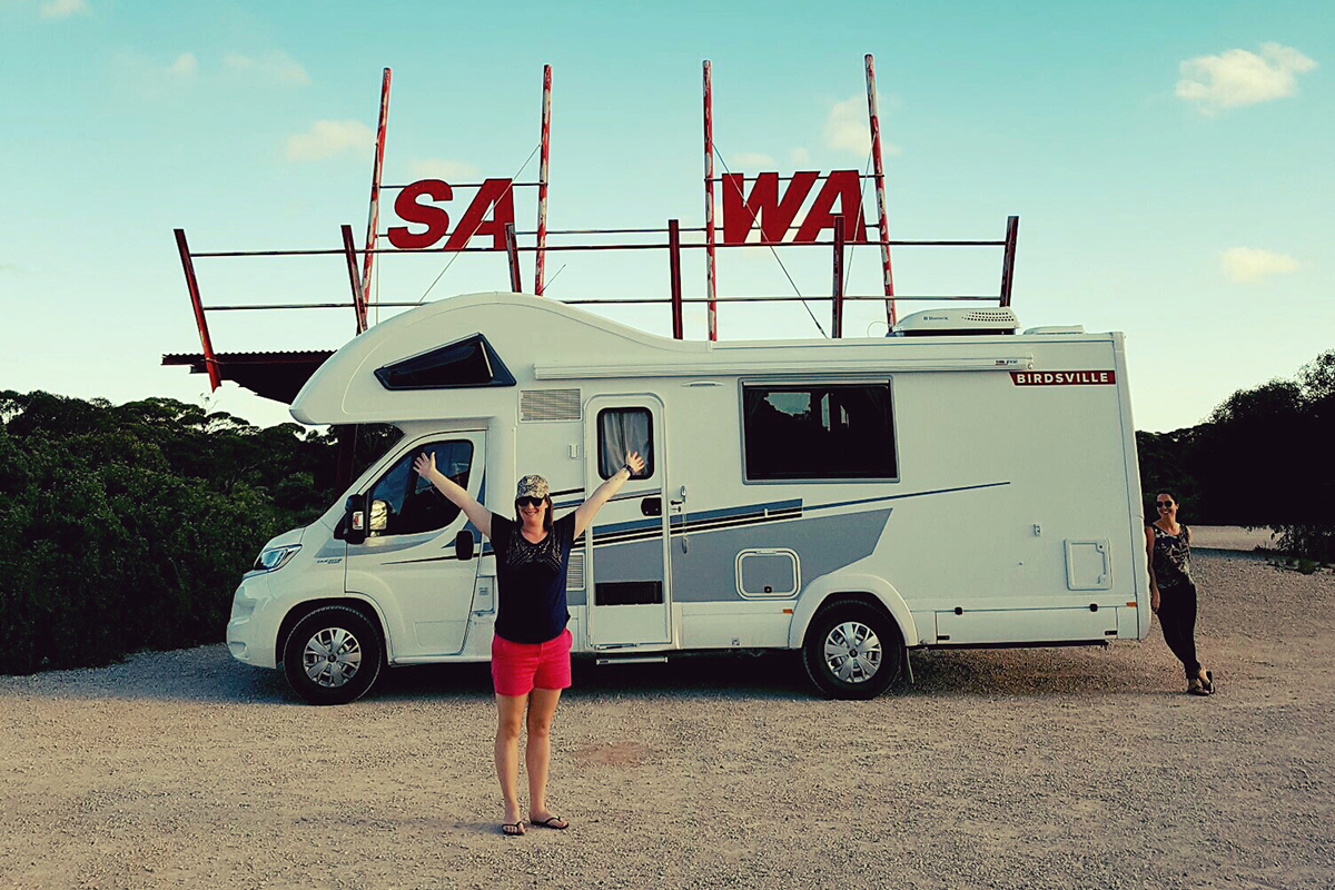 Two-women-standing-next-to-a-motorhome-on-the-border-of-SA-and-WA